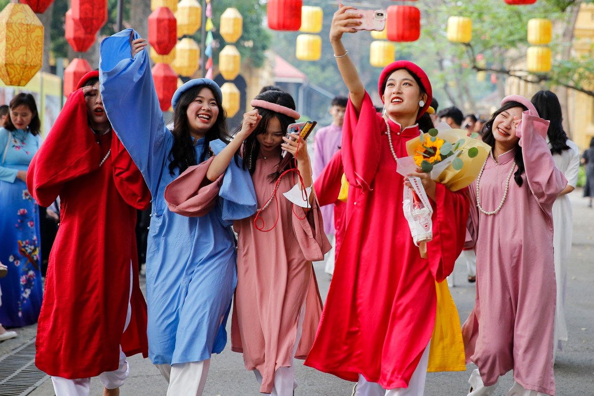 Young people in Hanoi wear traditional costumes to check-in at the Imperial Citadel of Thang Long